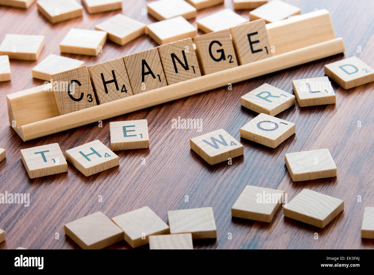 April 4, 2015:  Houston, TX, USA - Scrabble Word Game wood tiles spelling CHANGE THE WORLD Stock Photo