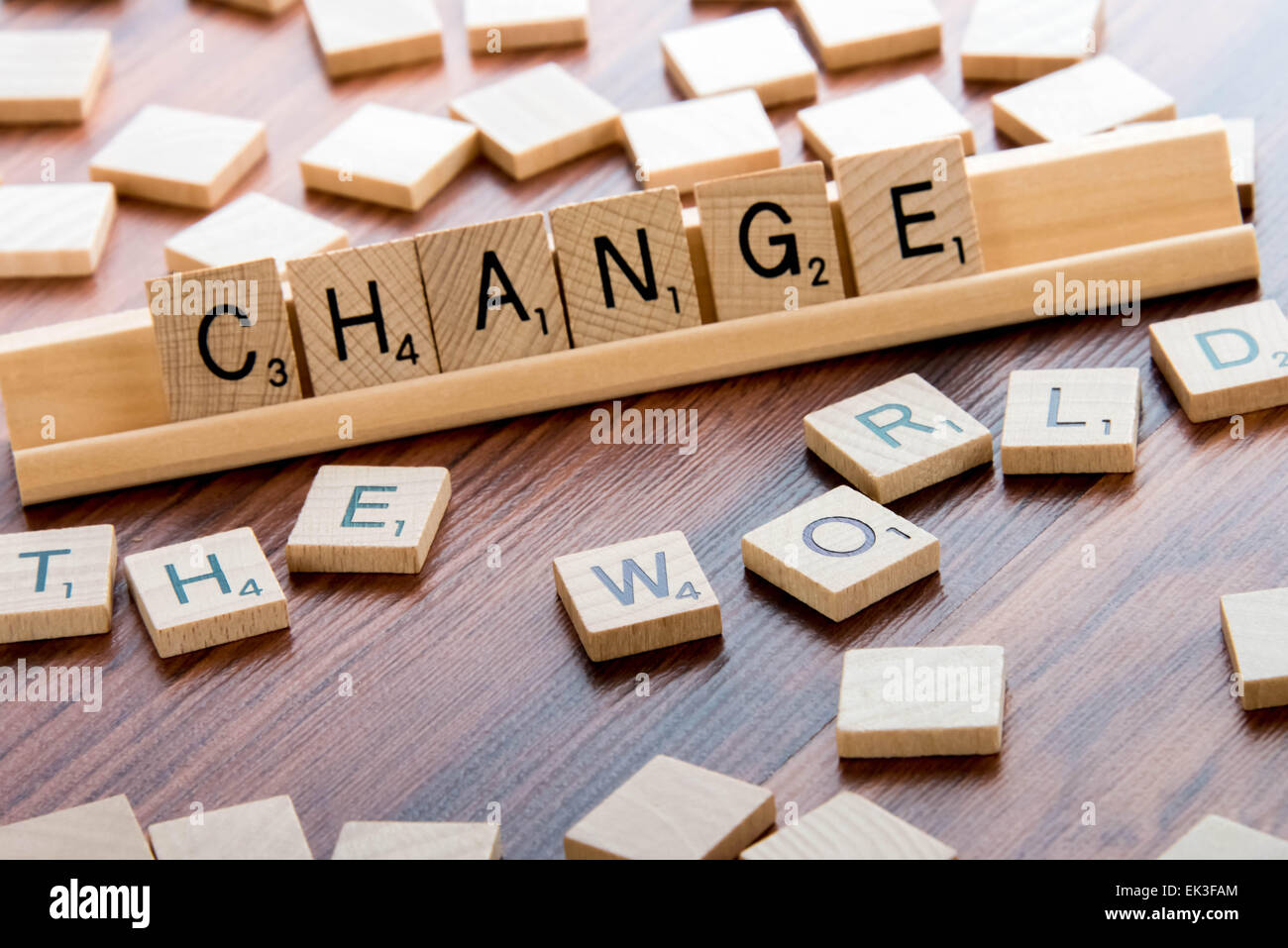April 4, 2015:  Houston, TX, USA - Scrabble Word Game wood tiles spelling CHANGE THE WORLD Stock Photo