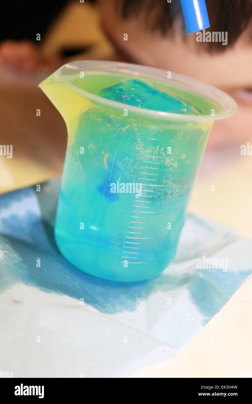 ice cube colored plastic cup for scientific experiments Stock Photo