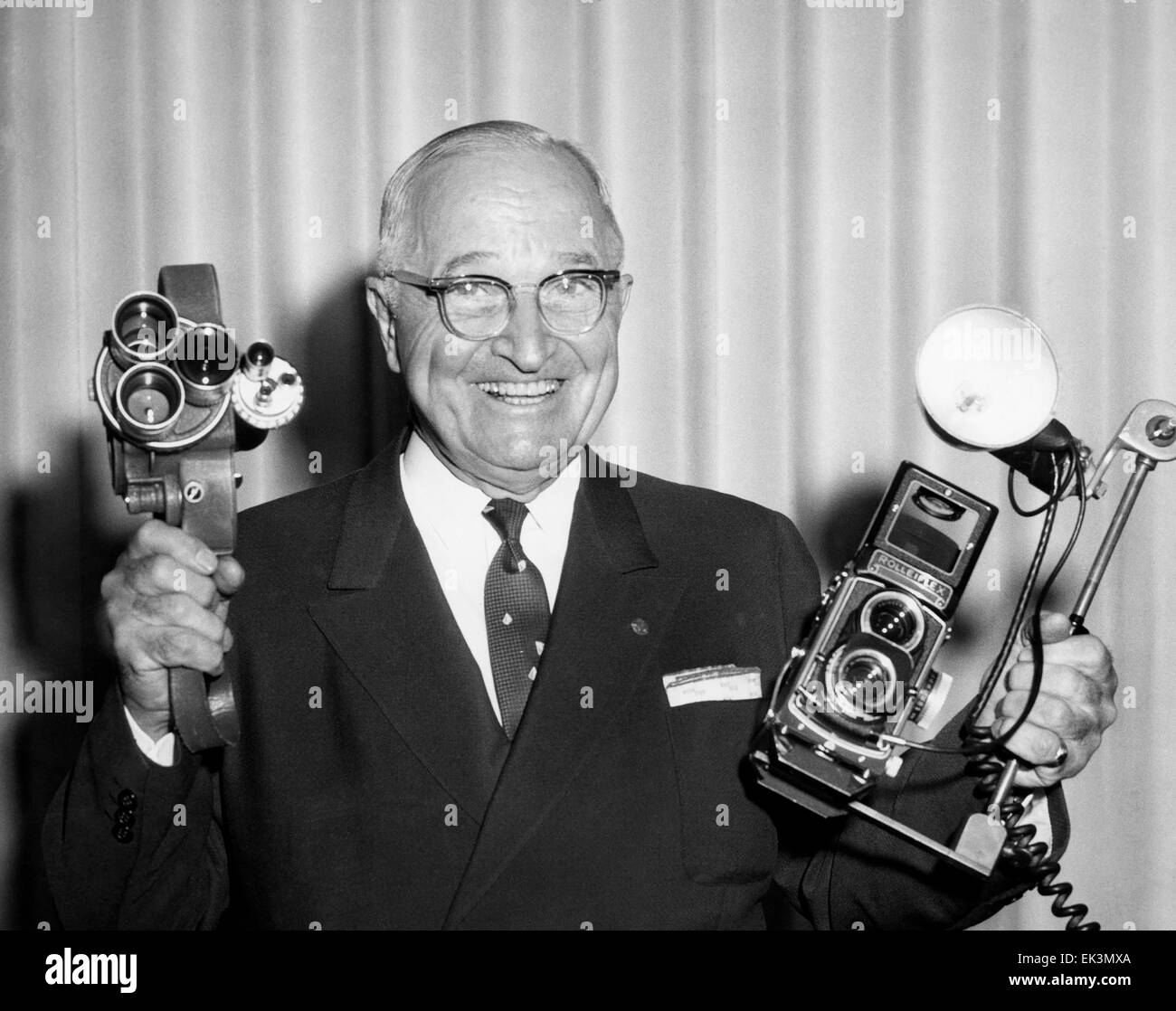 Former U.S. President Harry S. Truman, Smiling Portrait Holding Two Cameras, June 1960 Stock Photo