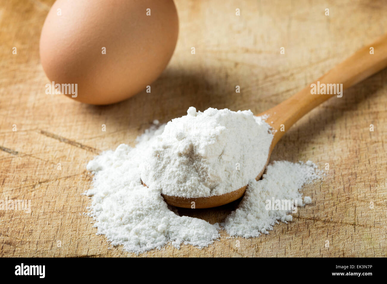 Flour and eggs on a wooden board Stock Photo