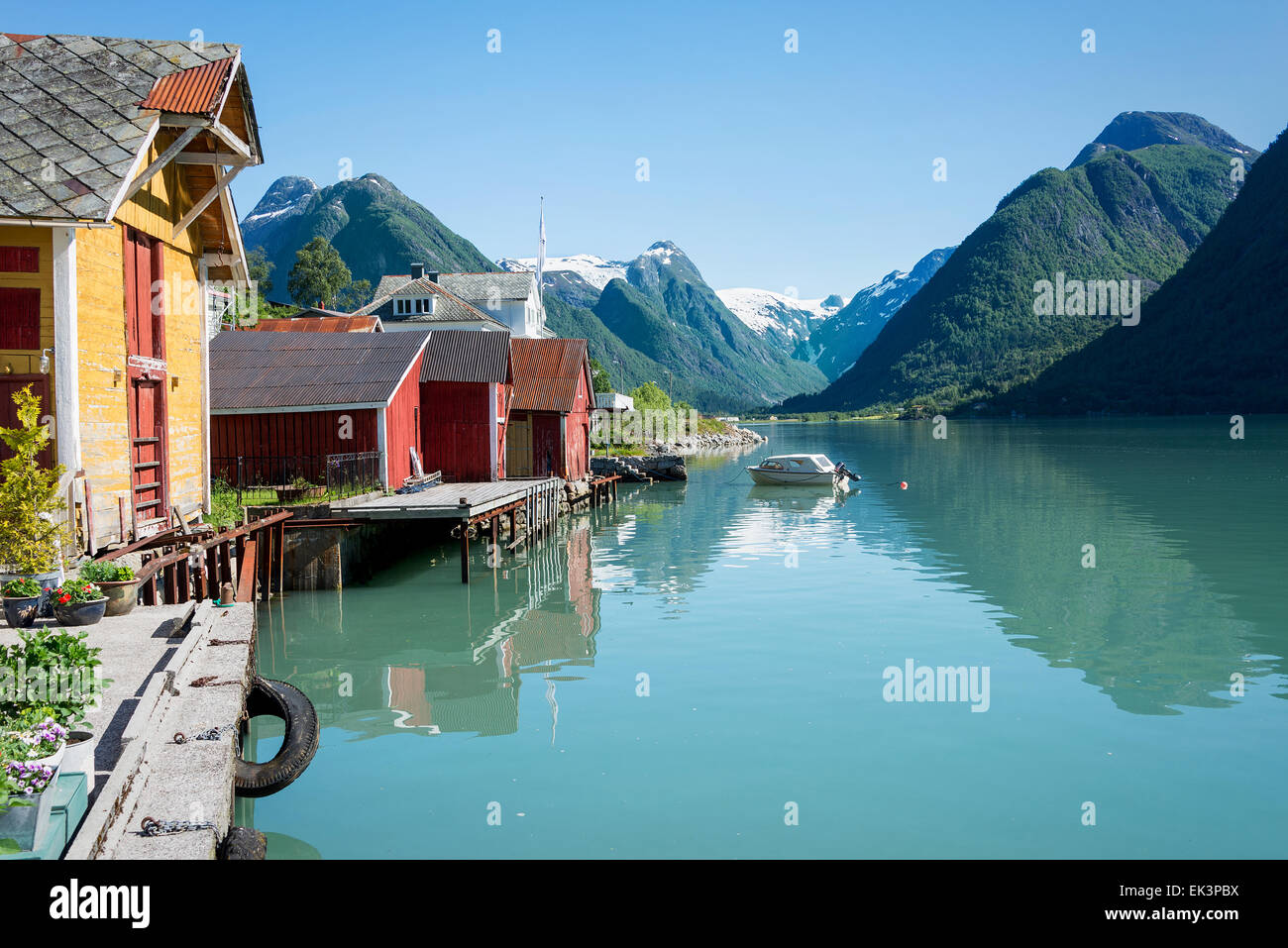 View over the fjord Fjaerlandsfjord and the small village of Mundal (or Fjaerland) with some snow-capped mountains in Norway. Stock Photo
