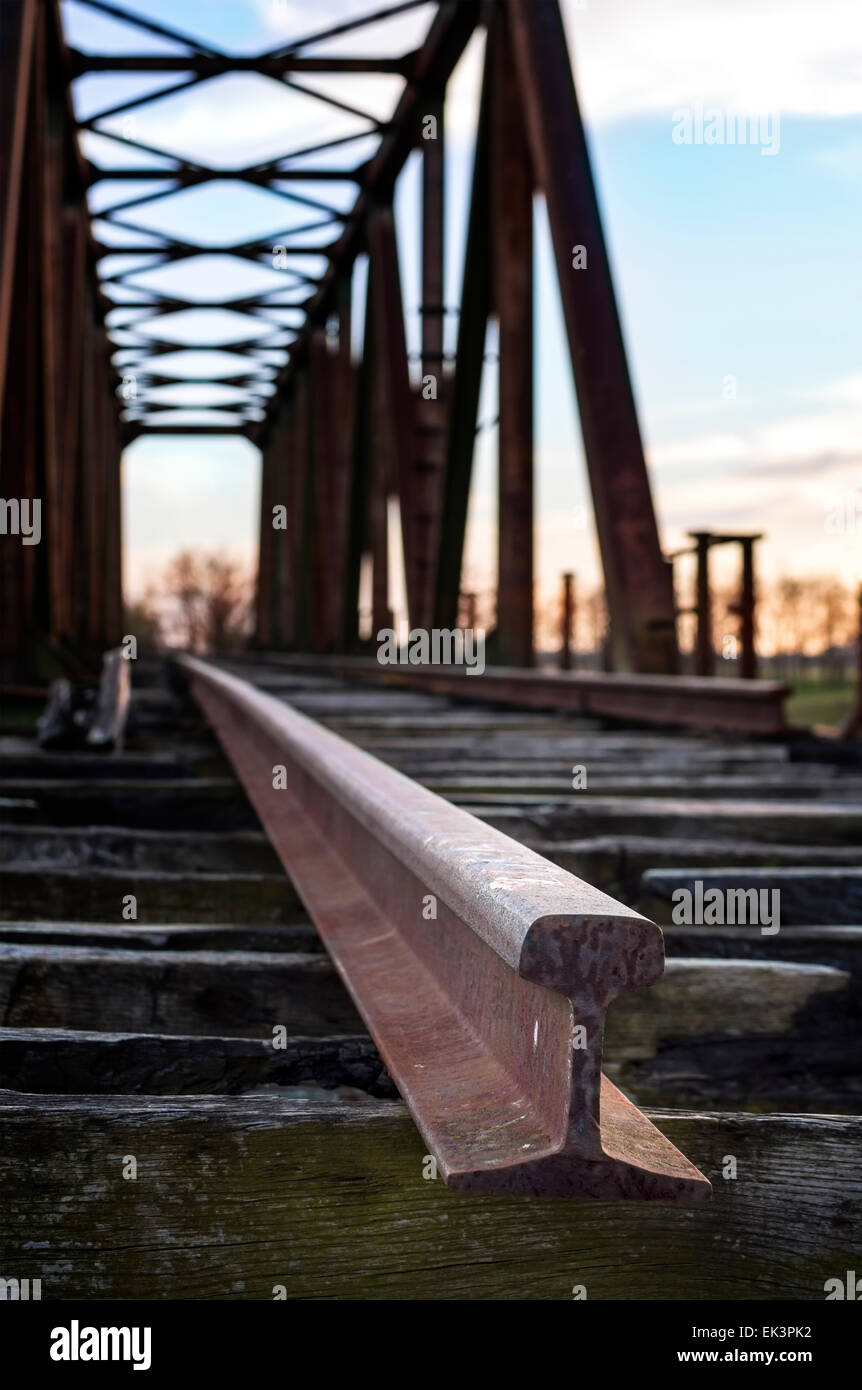 Old railway bridge. Selective focus on rail. Stock Photo