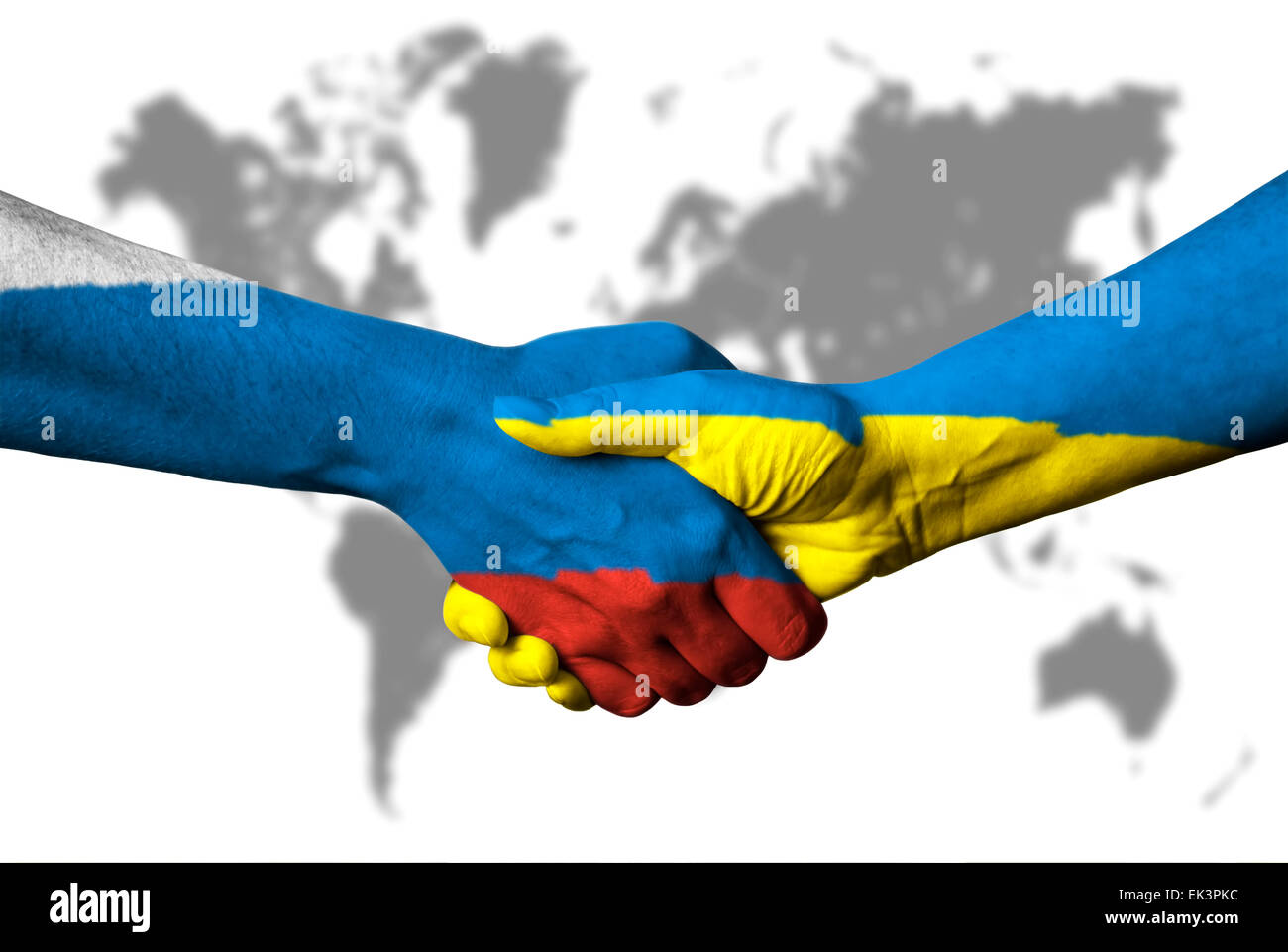 Russian flag and Ukraine flag across handshake in front of world map. Stock Photo