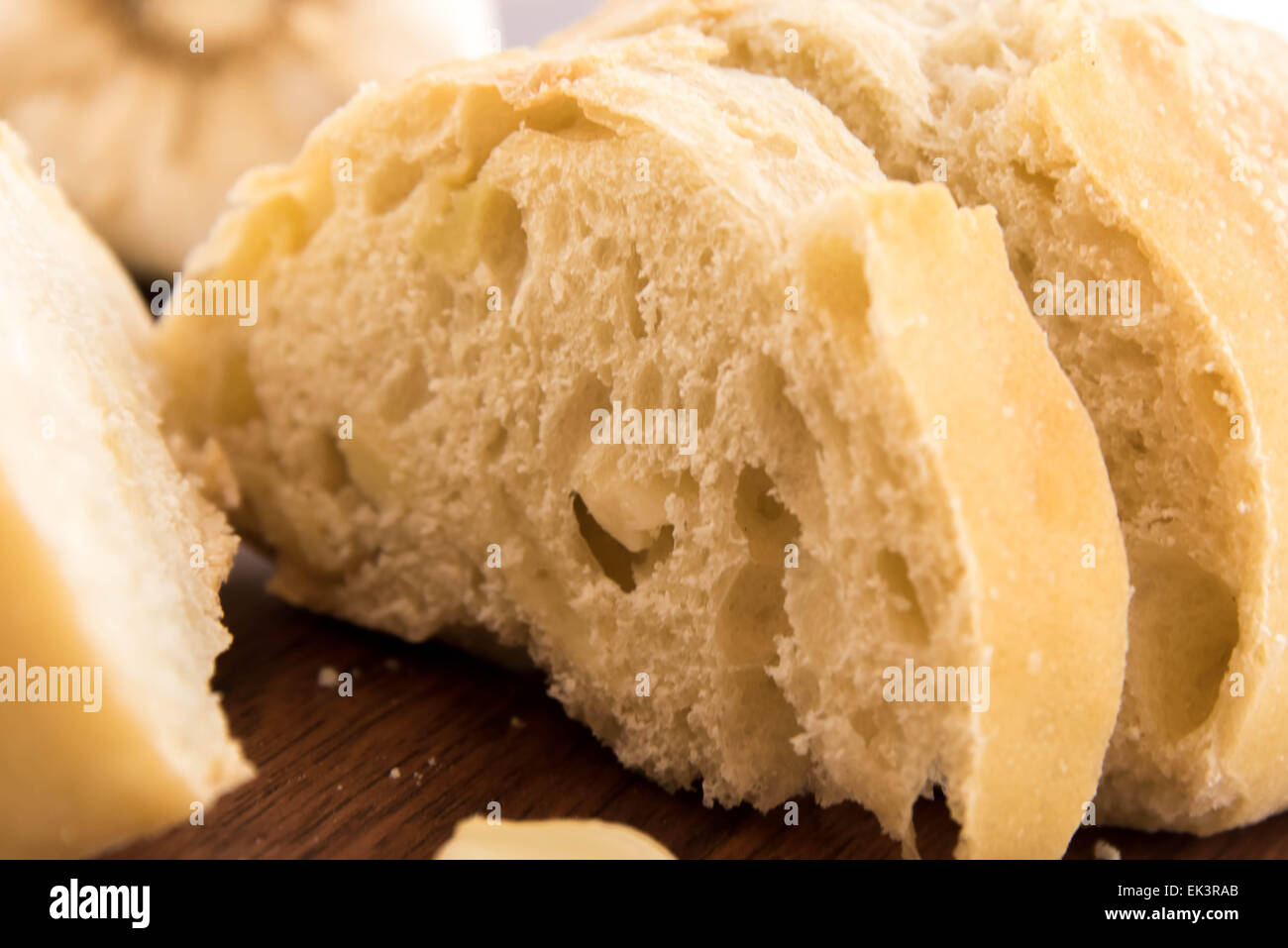 a fresh baked loaf of bread with whole cloves of roasted garlic Stock