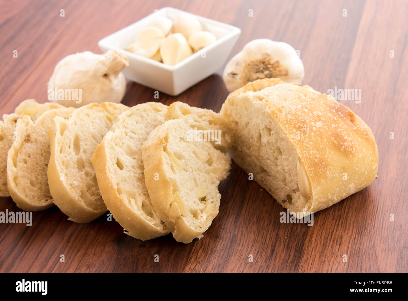 a fresh baked loaf of bread with whole cloves of roasted garlic Stock
