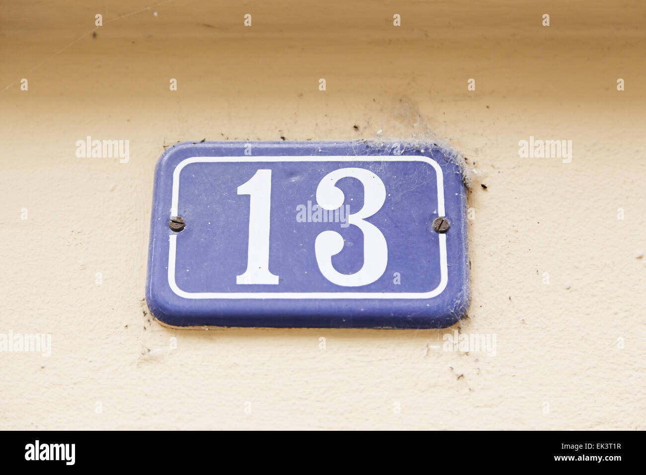 Number thirteen on a wall, detail of a number of information, odd ...