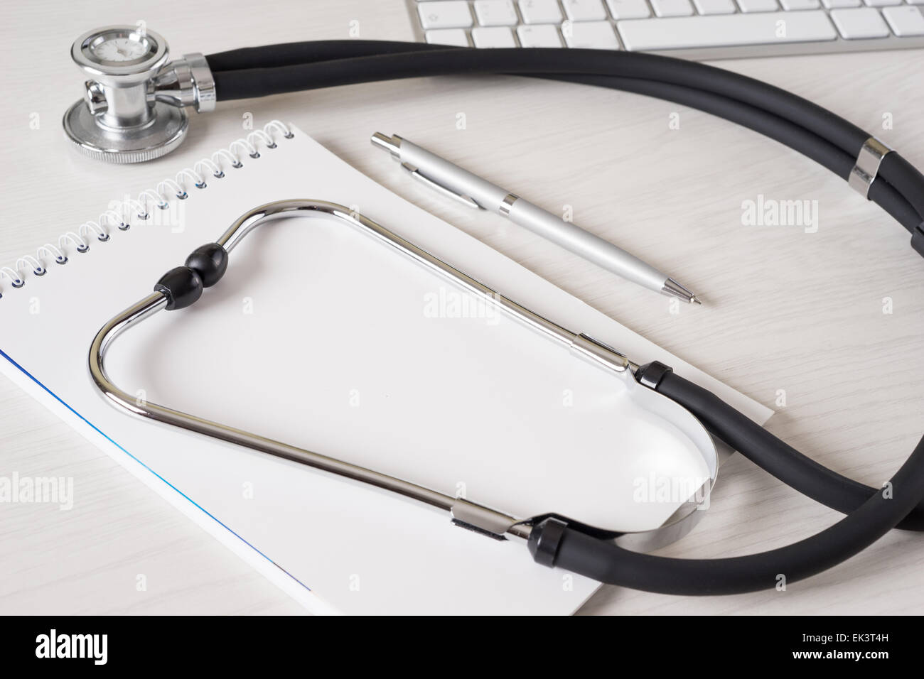 Workplace with notepad and keyboard, and stethoscope Stock Photo - Alamy