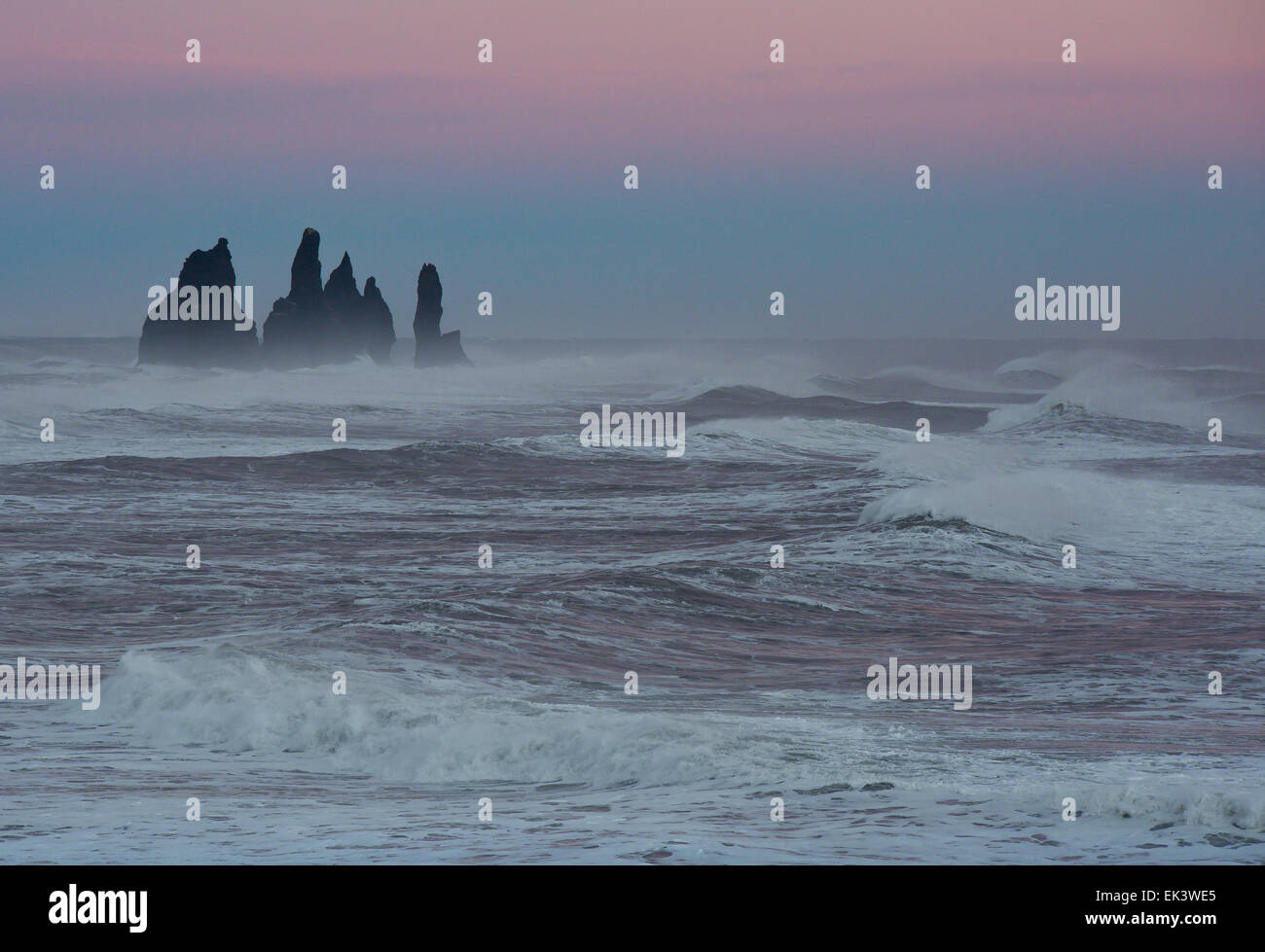 Sea stacks standing proud in the evening light and stormy seas around Vik, on the south coast of Iceland Stock Photo