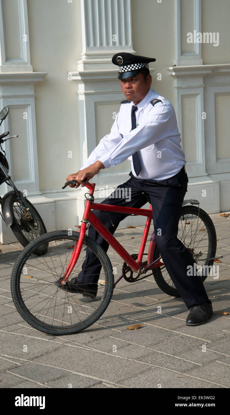 Security guard riding a bicycle that has no brakes The cycle is being