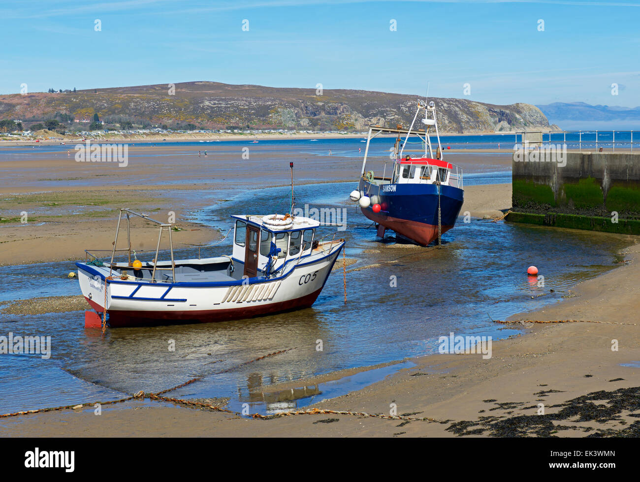 Two fishing boats beached near harbour wall at low tide, Abersoch, LLyn