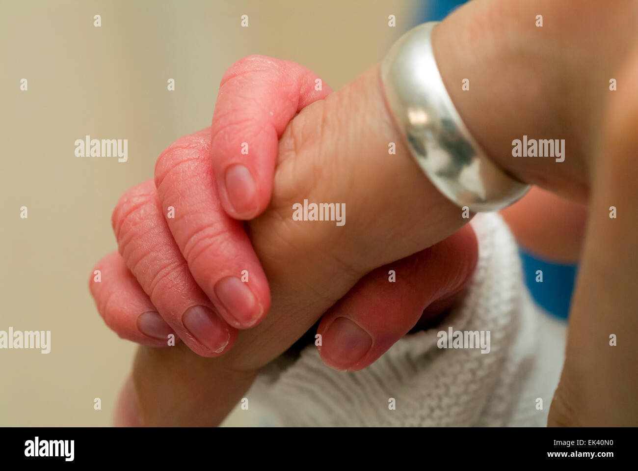 Hand of a newborn baby graps  finger of a parent Stock Photo