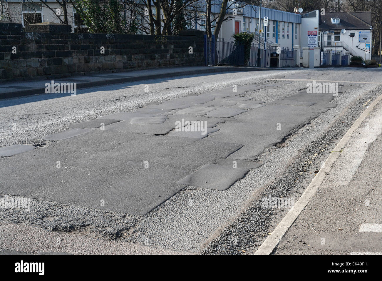 Uneven poor quality road surface patched repairs, Archer road in