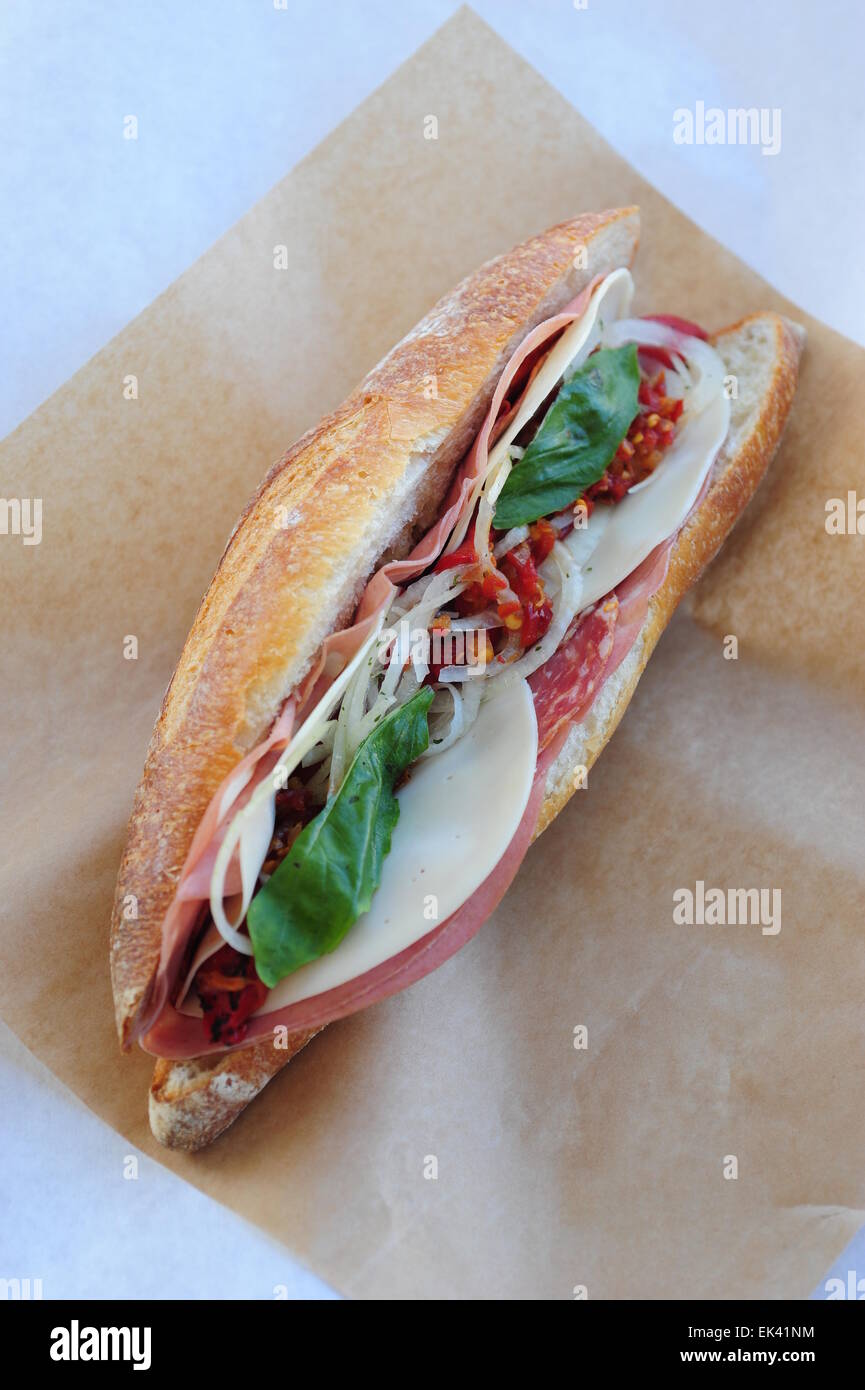 USA Food Italian cold cut sub hoagie sandwich basil meats cheeses on a hard bread roll Stock Photo