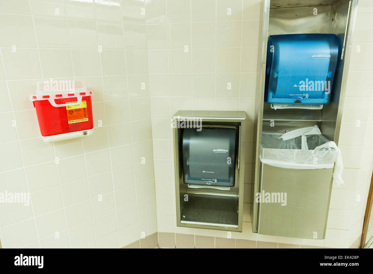 Safe needle / hazardous material disposal box and paper towel dispensers mounted on the wall in the public restroom Stock Photo