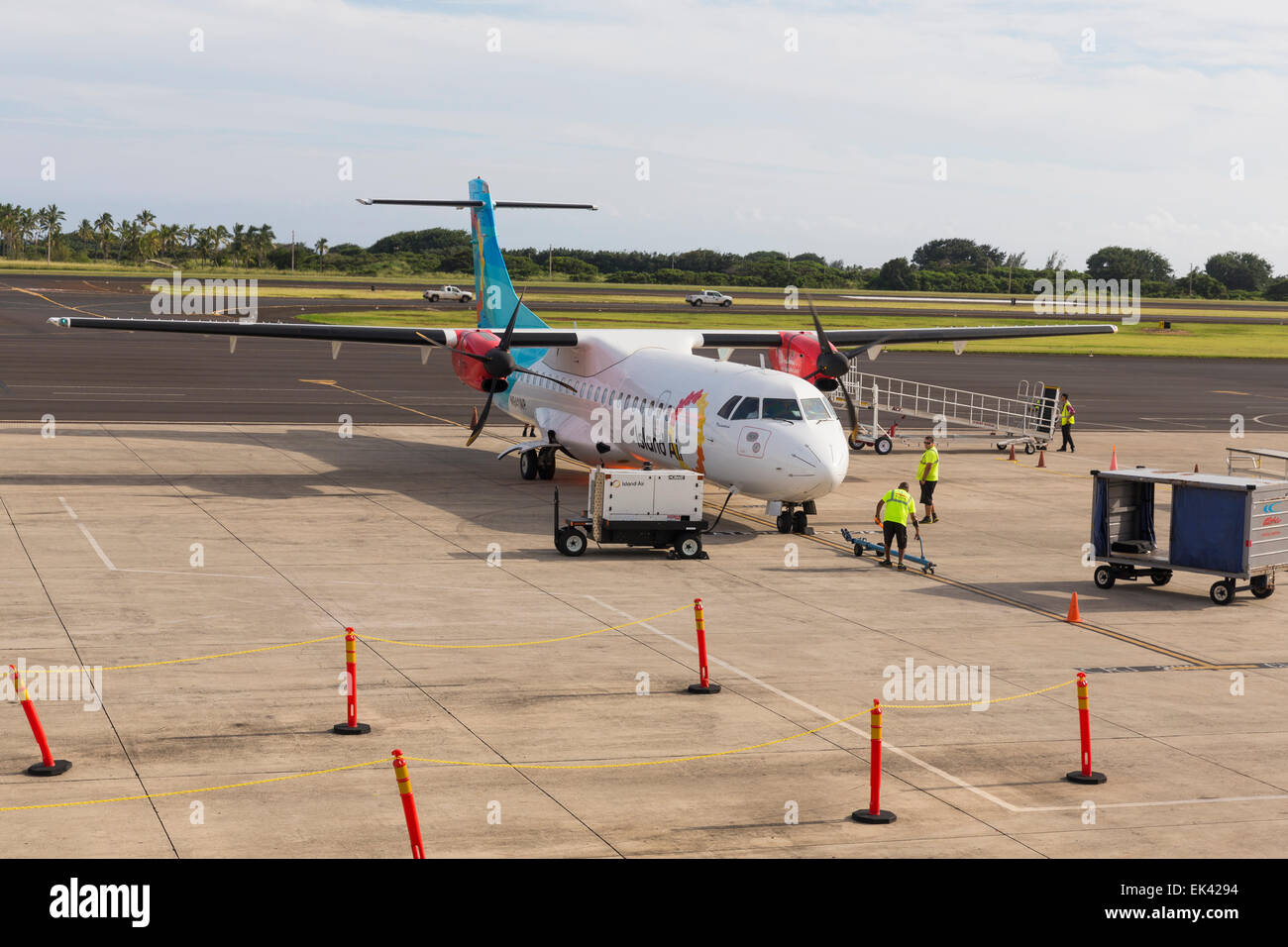 Small aircraft being prepared for departure - workers on the tarmac Stock Photo