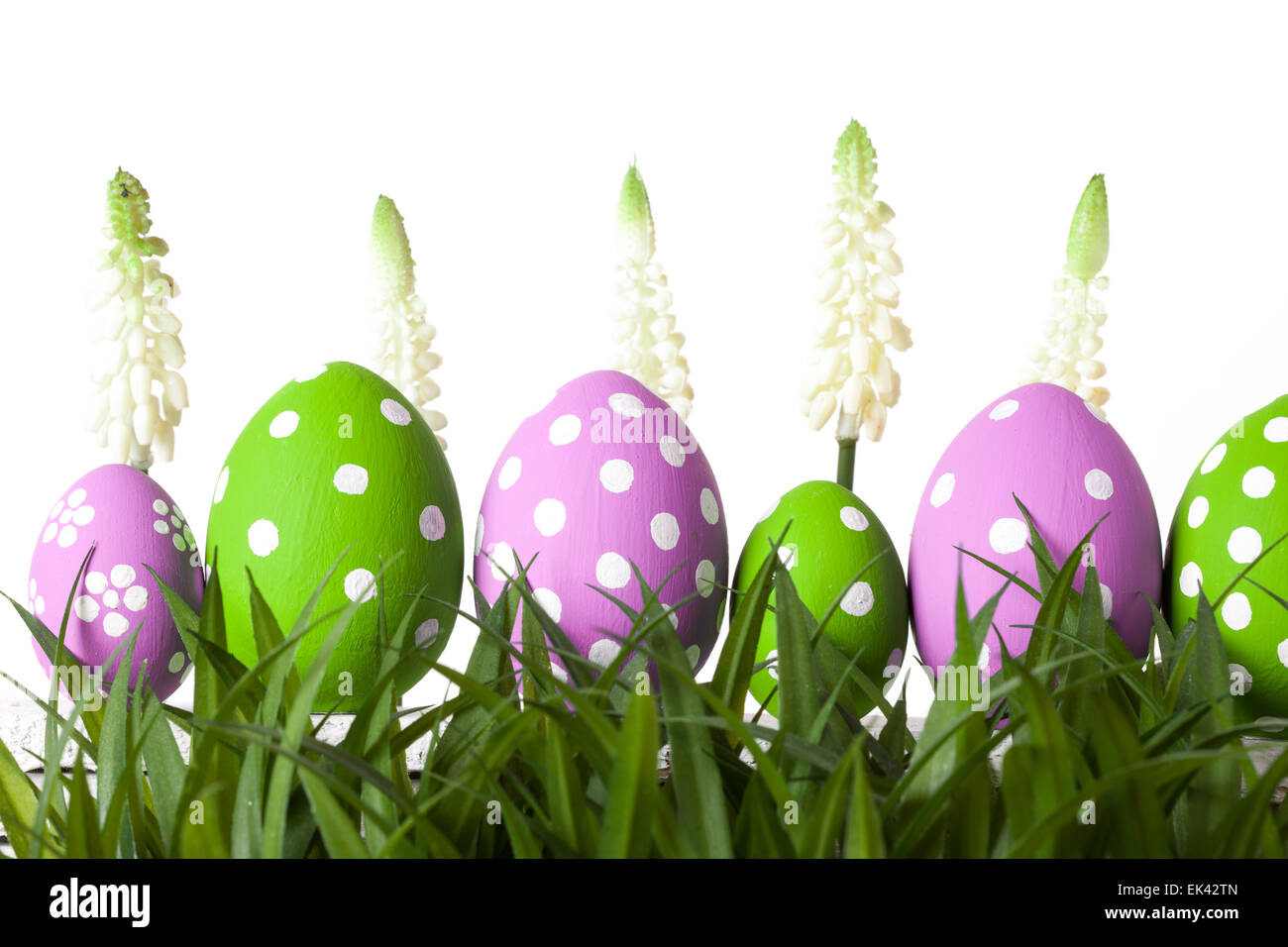 Row of Easter eggs in Fresh Green Grass Stock Photo
