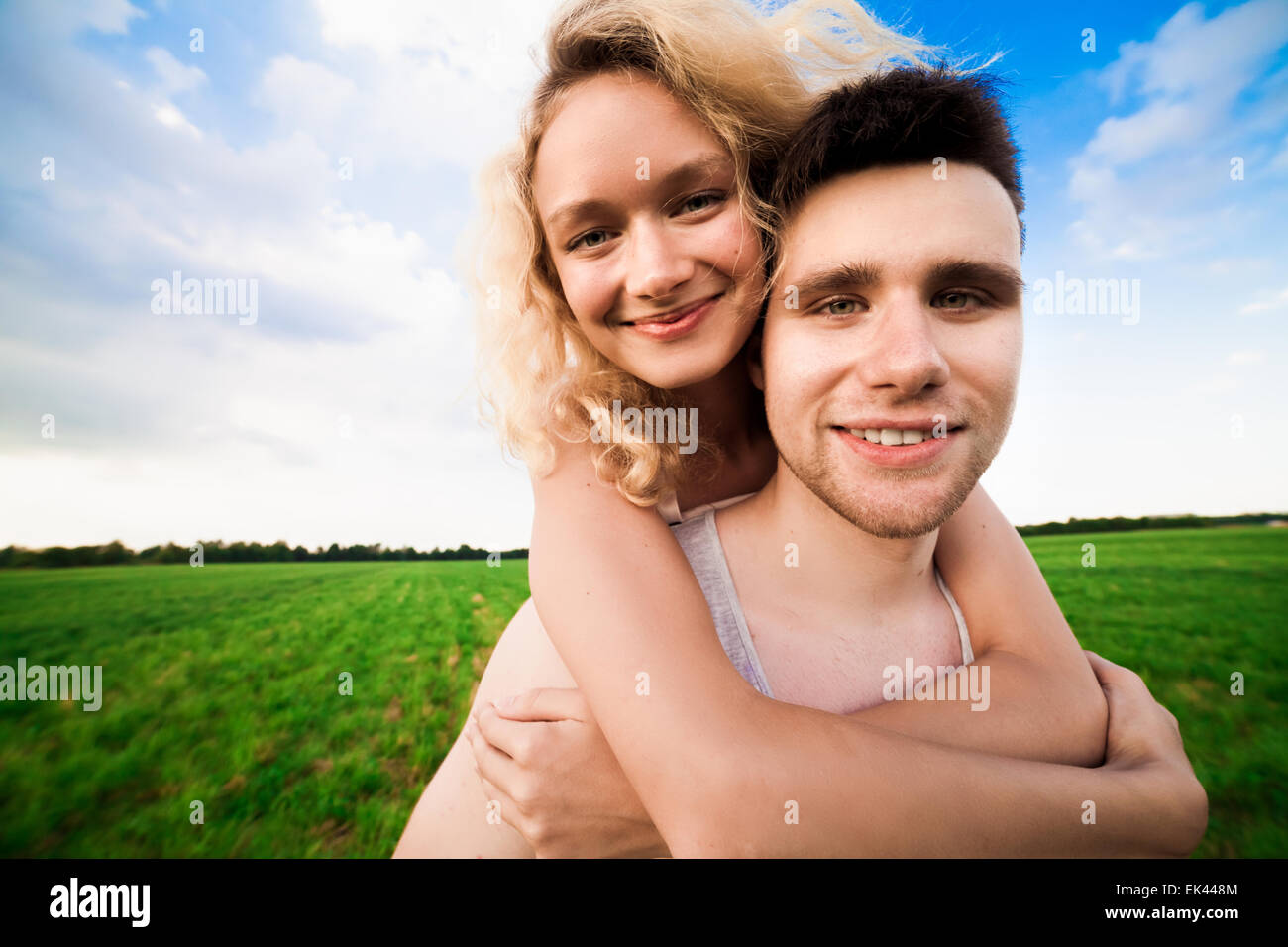 The couple smiles against a background sky Stock Photo - Alamy