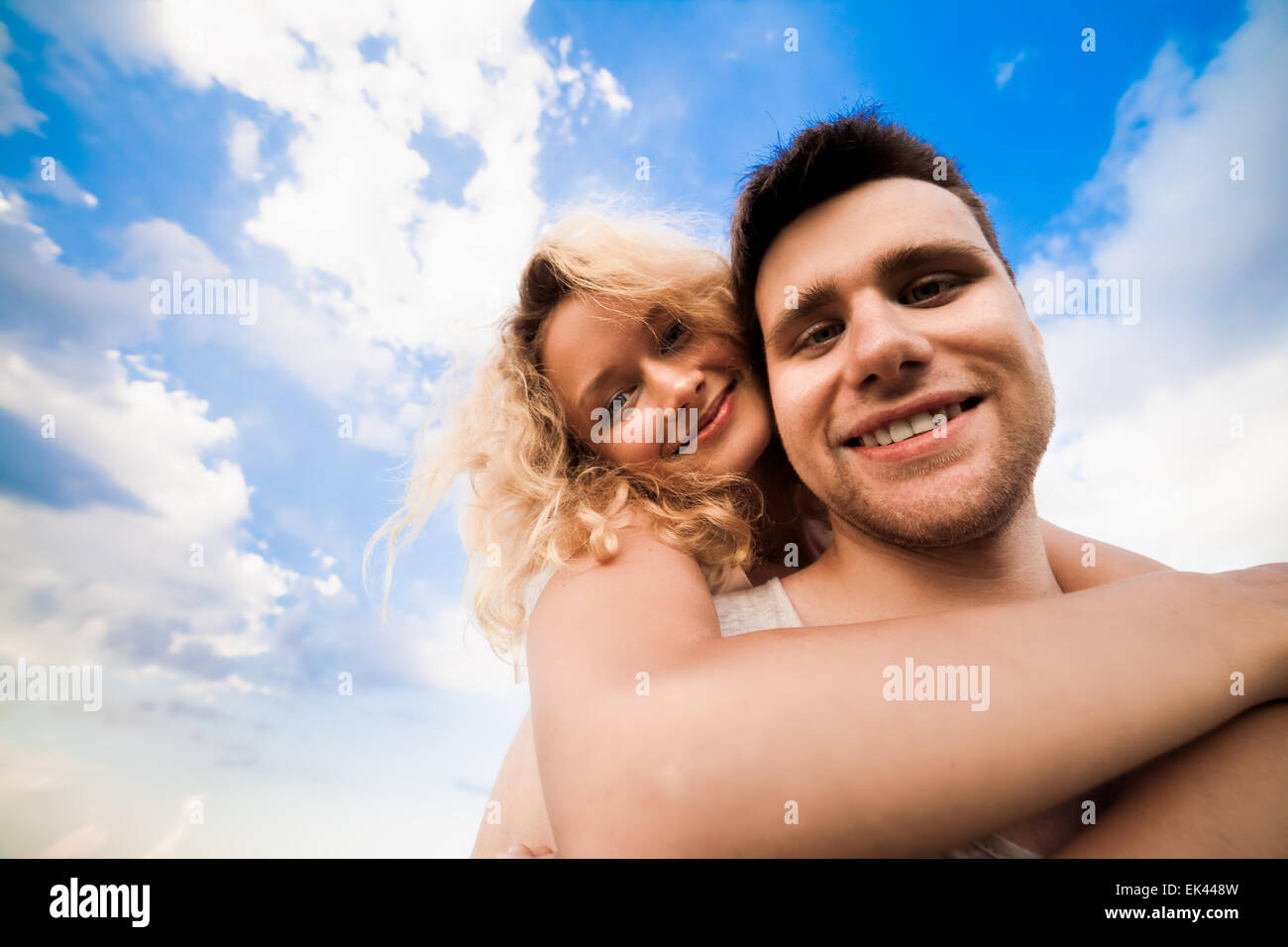 The couple smiles against a background sky Stock Photo - Alamy