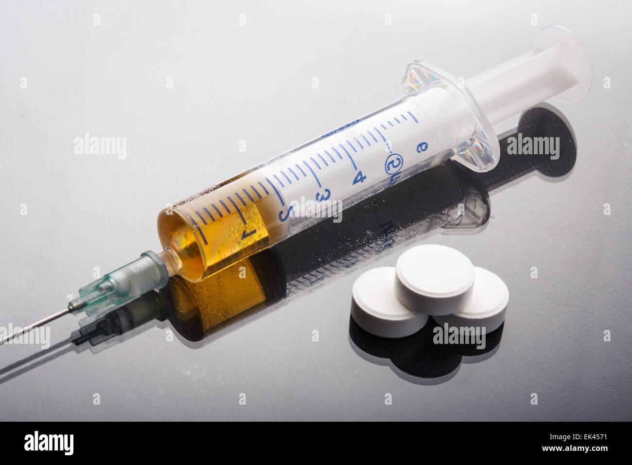 Drug syringe and cooked heroin Stock Photo