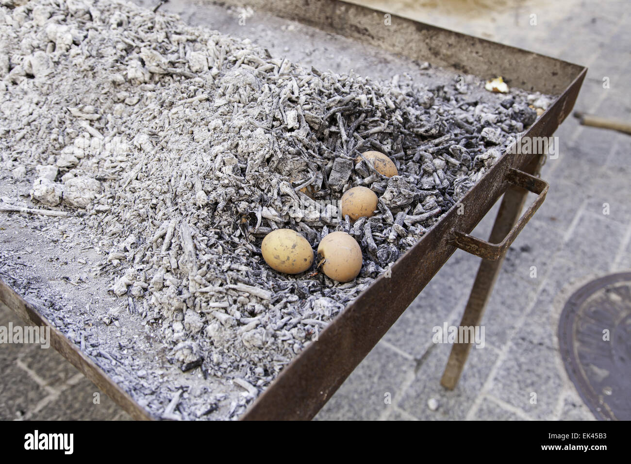 Eggs in a charcoal grilling, detail of how to cook some eggs, feed and