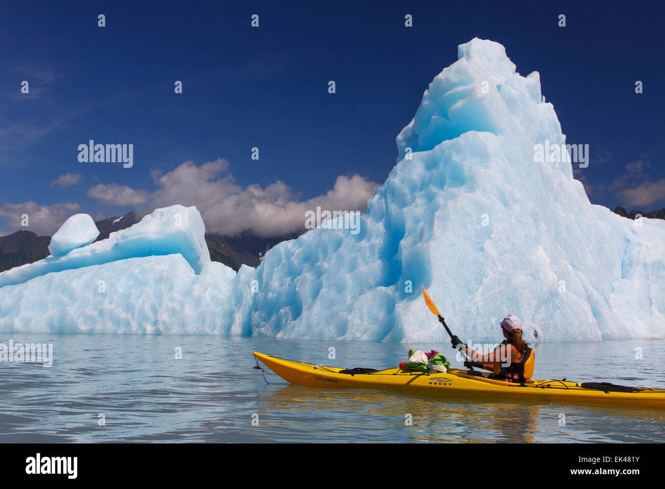 Kayaking in Bear Glacier Lagoon, Kenai Fjords National Park, near Seward, Alaska.  (model released) Stock Photo