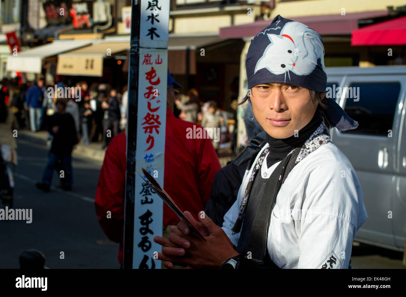 Rickshaw puller (driver? operator?) awaiting custom. Kyoto, Japan. Young Japanese man wearing traditional clothes; clothing; costume; jinrikisha; Asia Stock Photo
