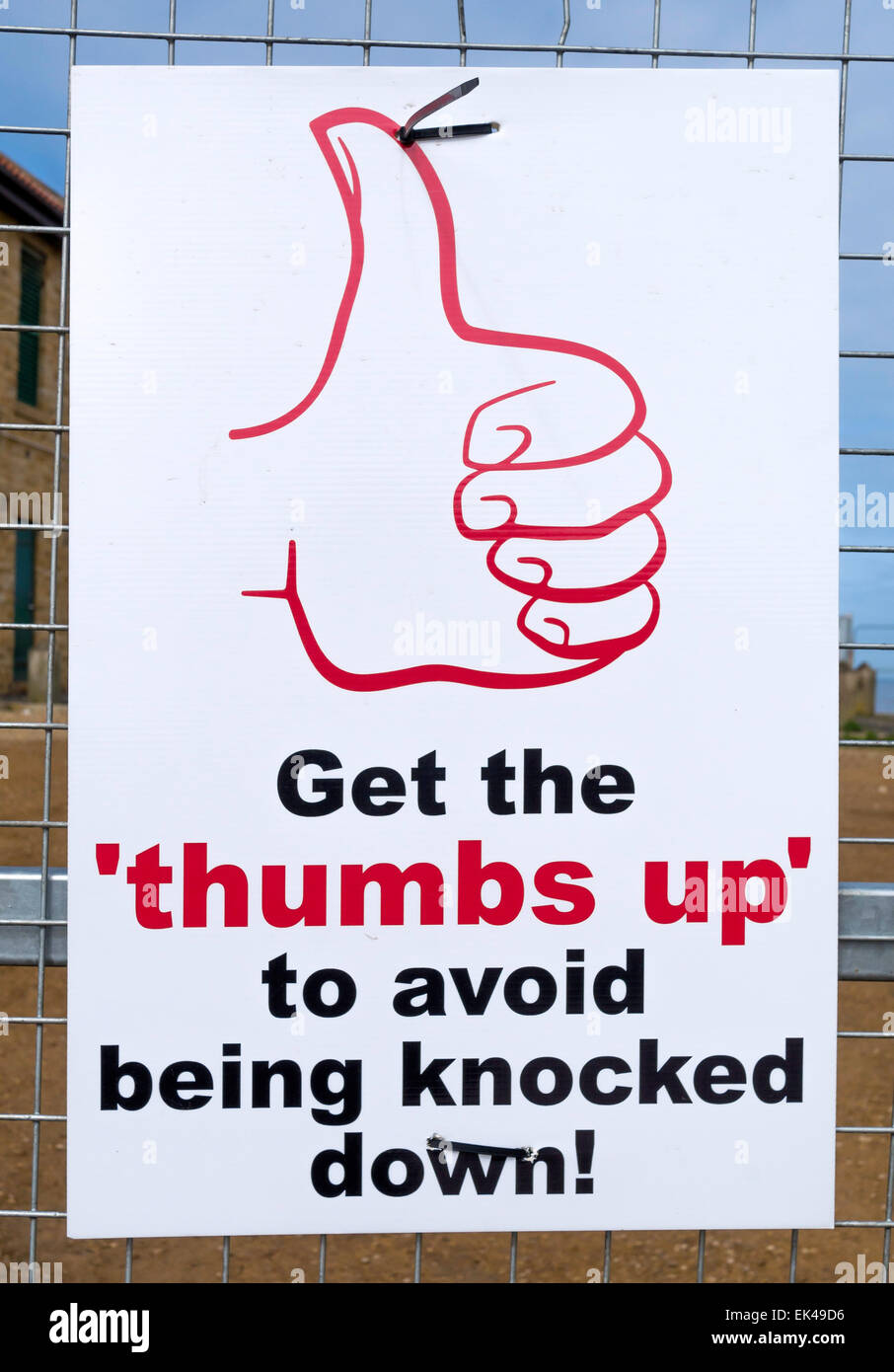 Construction site safety notice Get the ‘thumbs up’ to avoid being knocked down Stock Photo