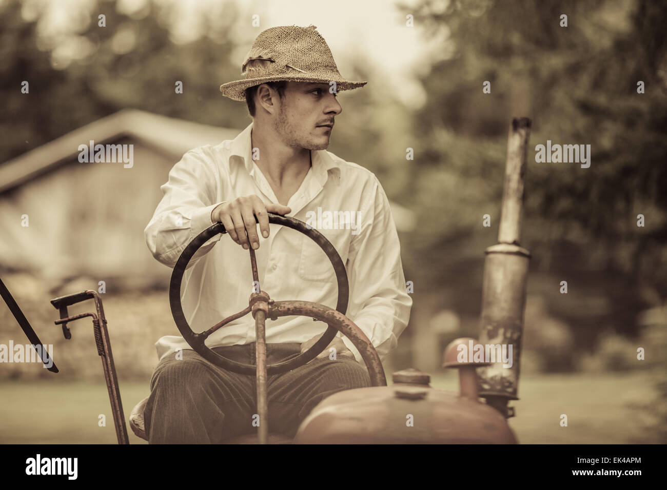 Young Farmer Driving a Red Old Vintage Tractor Stock Photo - Alamy