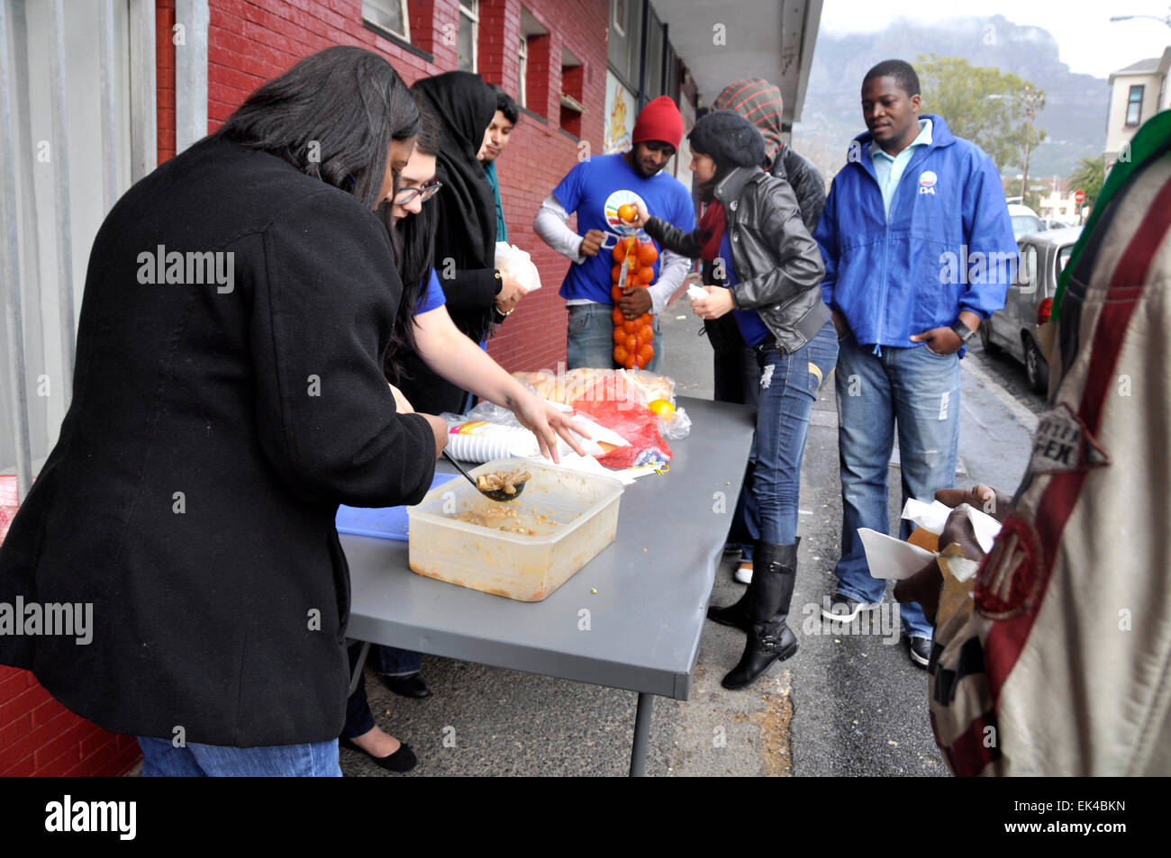 Some Democratic Alliance people doing their 67 minutes or more time to give in honour of Nelson Mandela's 95th birthday on Mandela day in central Cape Town, 18.07.2013. they chose to give food to street people . Stock Photo