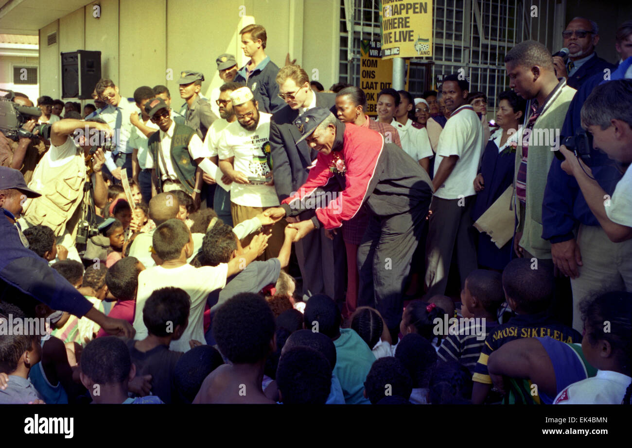 Nelson Mandela( red jacket) greets children at a clinic in Hanover Park