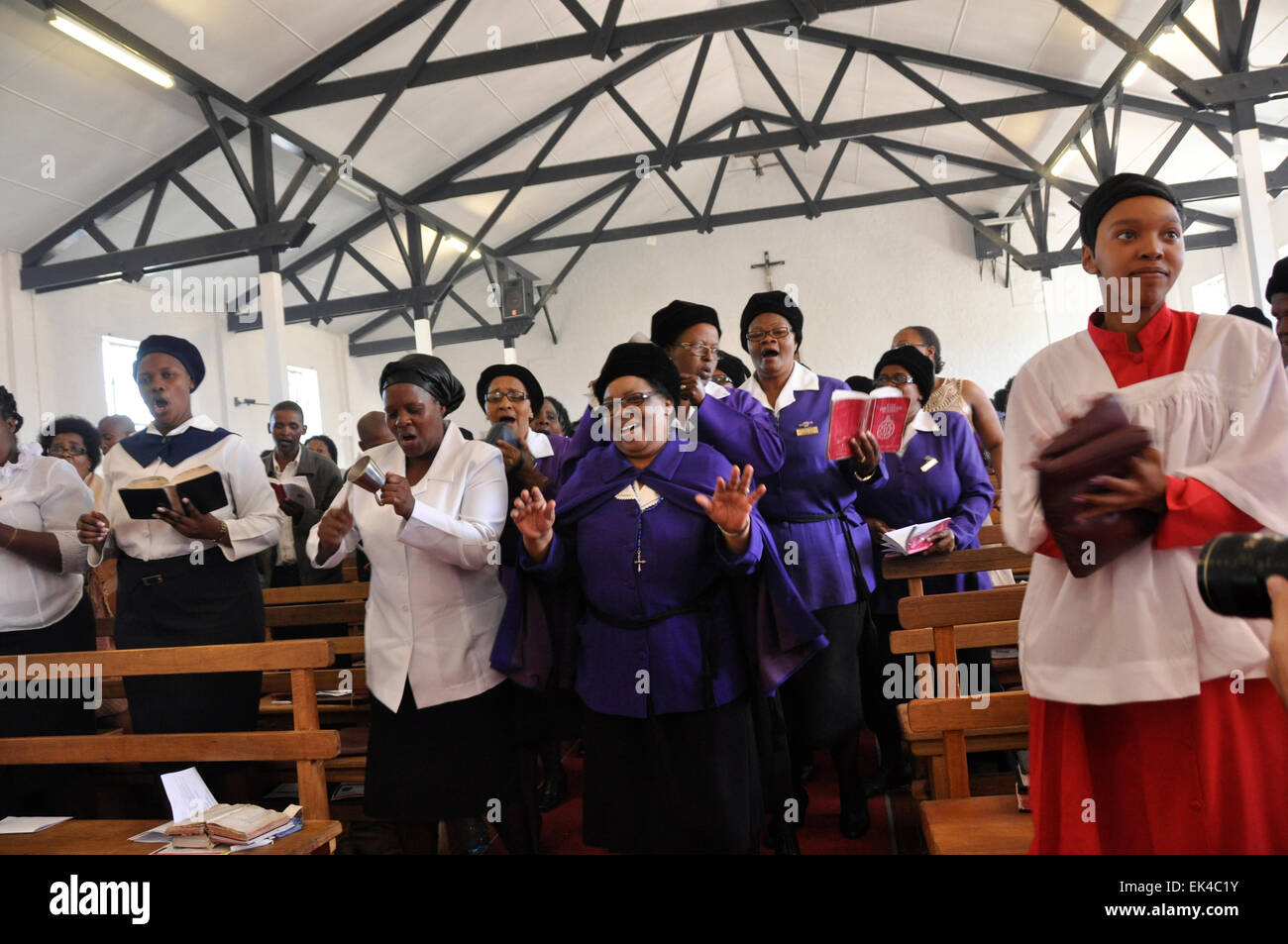 Holy Cross Church members mourn Mandela, nyanga, cape Town.South Africa mourns Mandela on  National Day of Prayer and Reflection on the life of former President Nelson Mandela.Sunday church services commemorated  the life of the beloved Madiba who passed away this week. A service in the predominantly black suburb of Nyanga, Cape Town resonated with exquisite choral music and was addressed by the Anglican Archbishop of South Africa the Most Revd. Thabo Makgoba in honour of Mandela.2013.12.08 Stock Photo