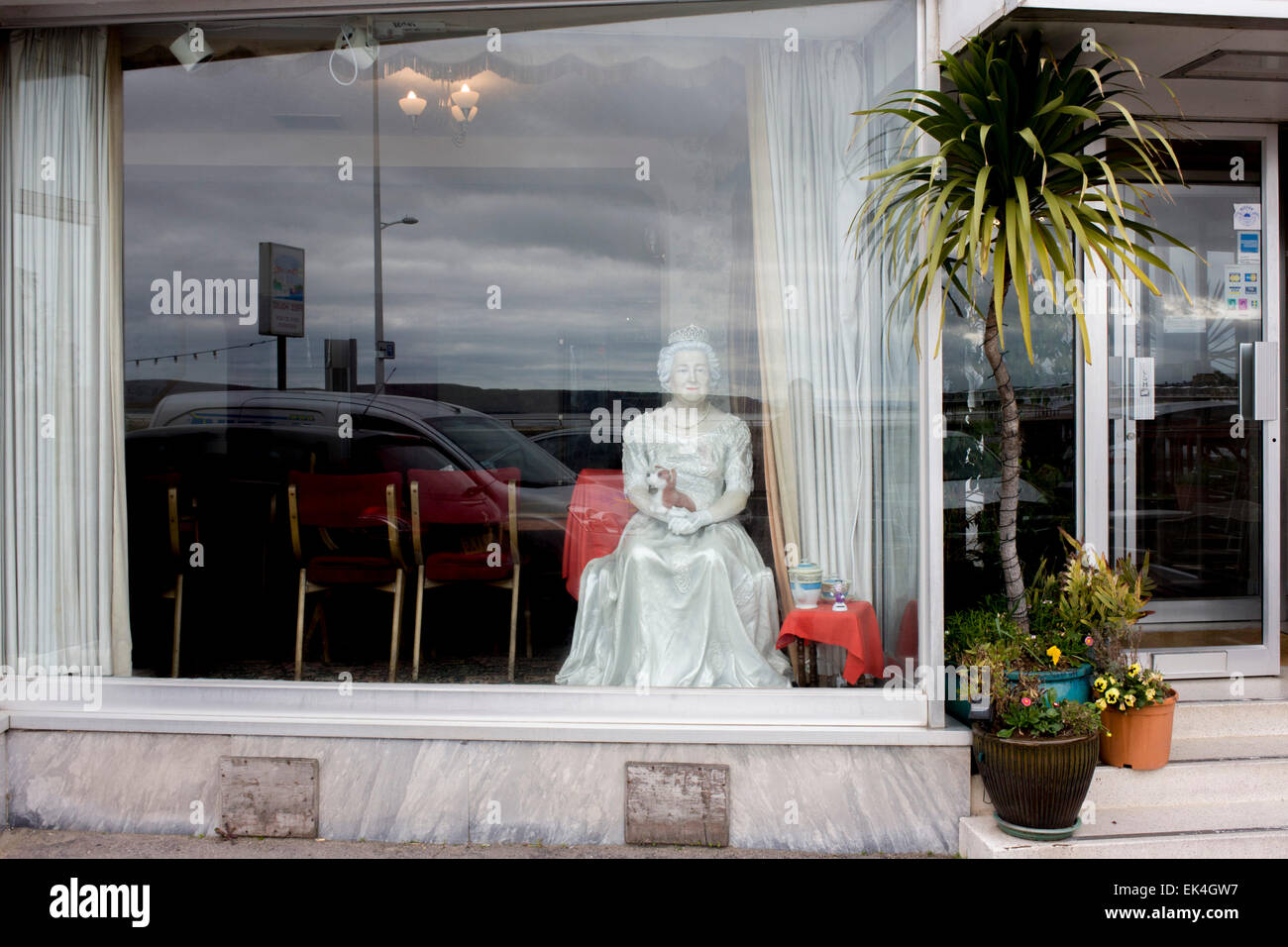 A mannequin of Queen Elizabeth appears in a hotel window on the seafront of Weston-super-Mare, north Somerset. Stock Photo