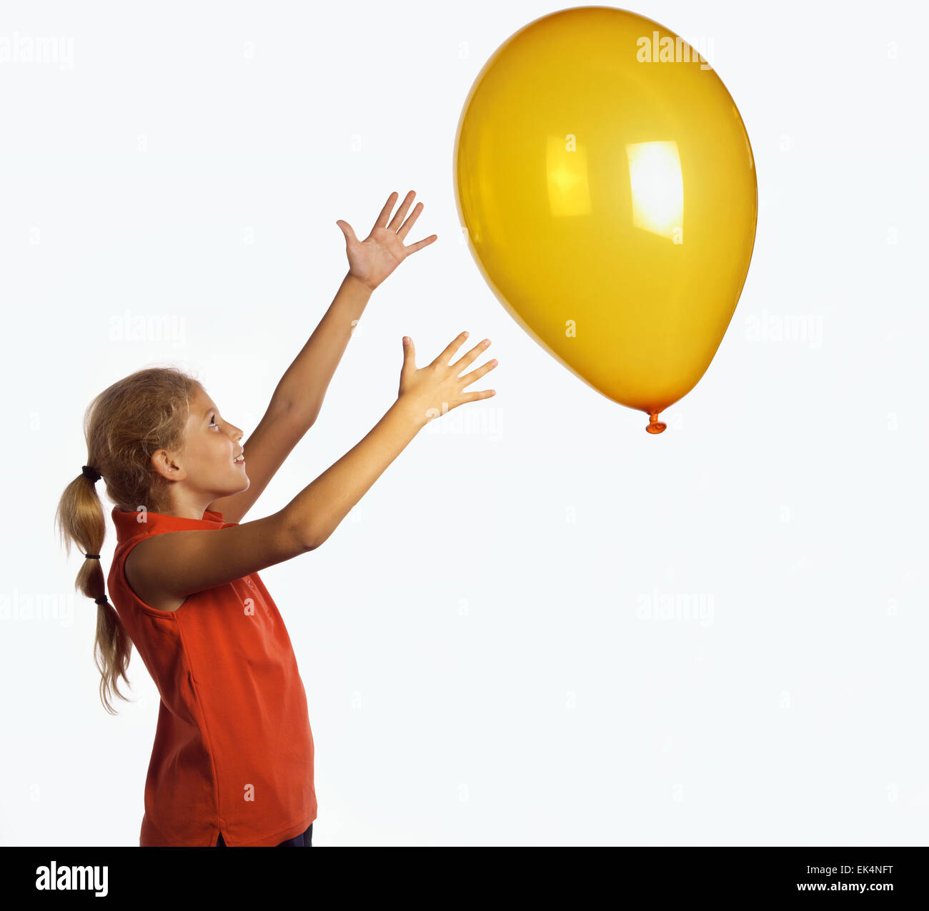 Italy, young girl playing with a baloon Stock Photo - Alamy