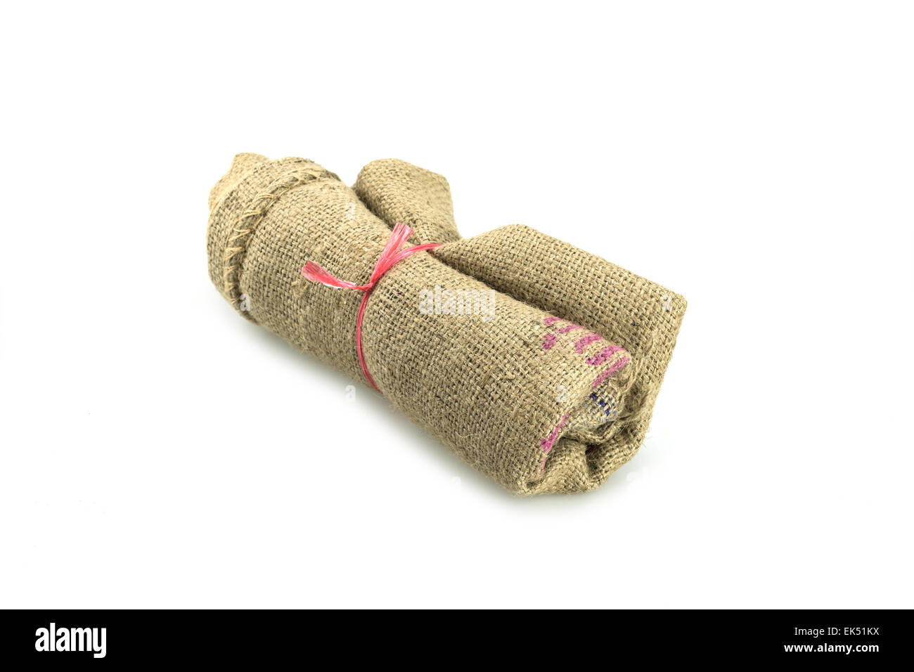 Roll of old sack or crumpled burlap isolated on white Stock Photo