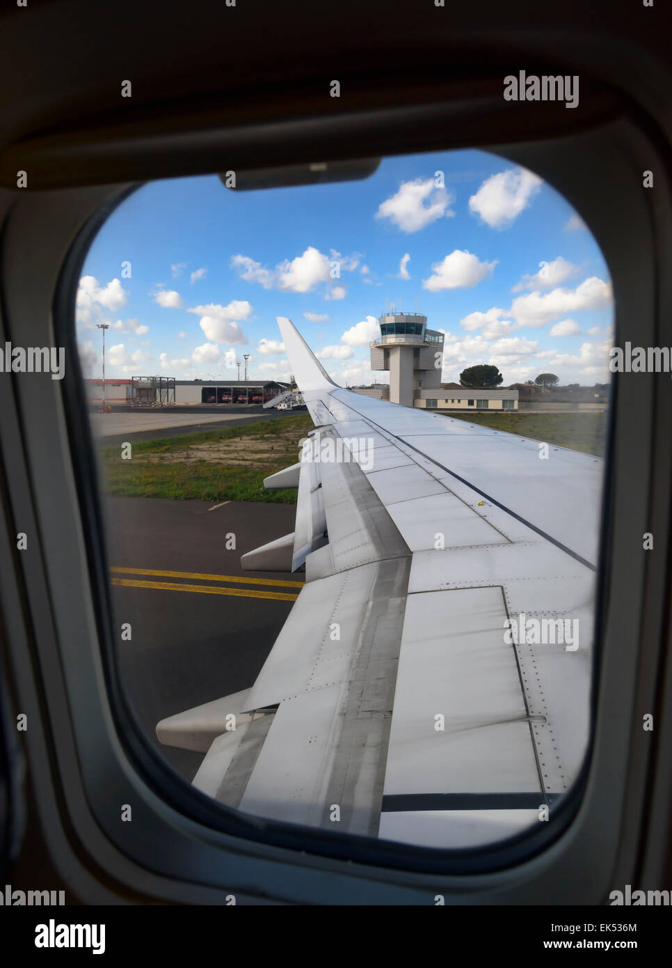 Italy, airplane wing and flight control tower in an airport Stock Photo