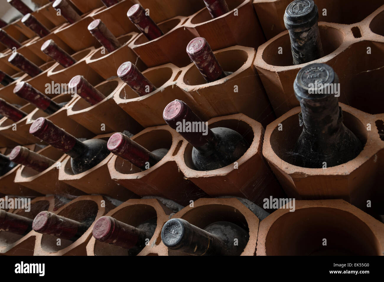 Italy, Sicily, old red wine bottles aging in a wine cellar Stock Photo