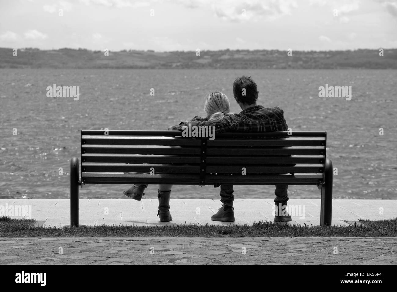Italy, Bracciano lake (Rome), young couple relaxing on a bench Stock Photo