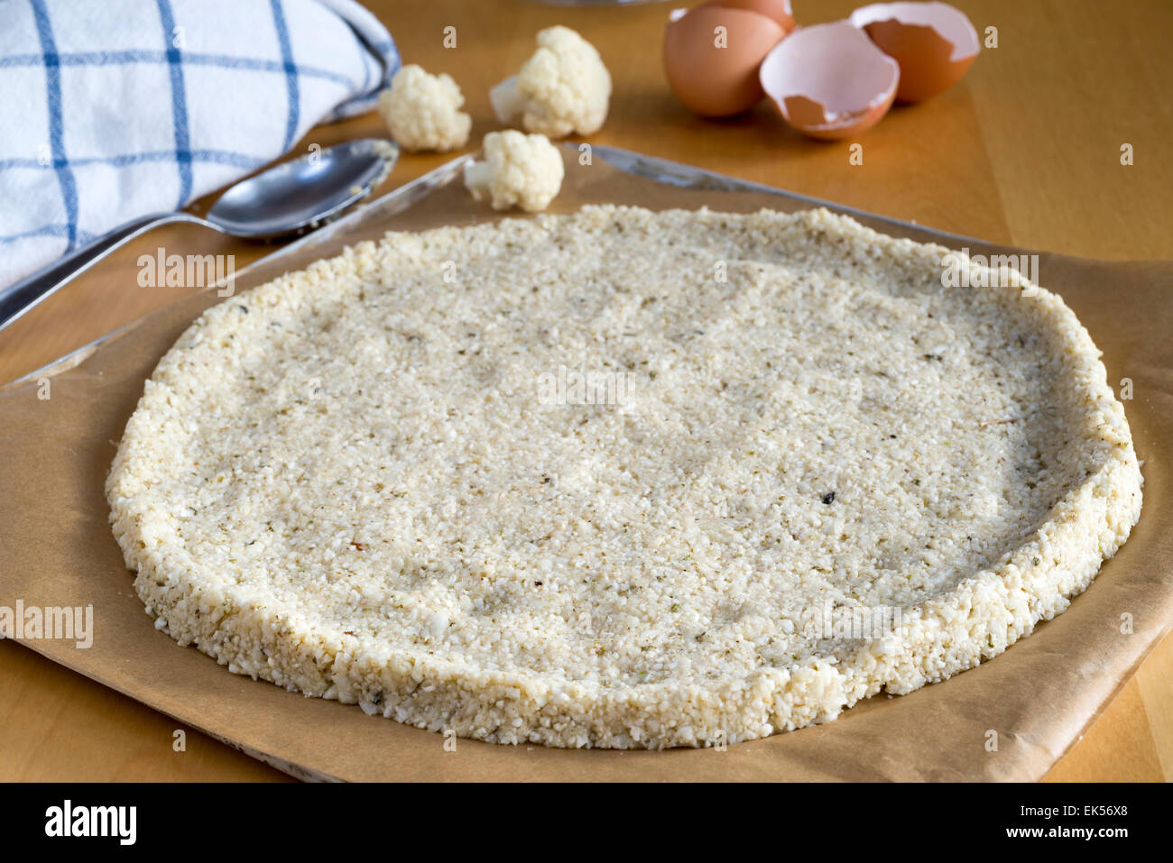 Pizza crust made from cauliflower 'rice' and eggs rather than traditional bread dough. Stock Photo