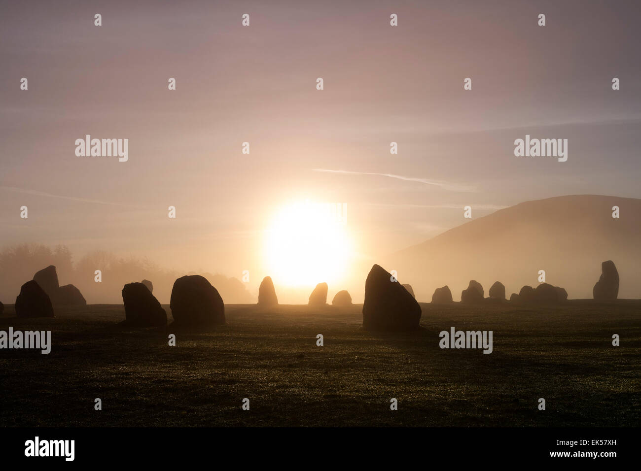 Sunrise Diffused by Early Morning Mist at the Castlerigg Stone Circle Lake District Cumbria UK Stock Photo