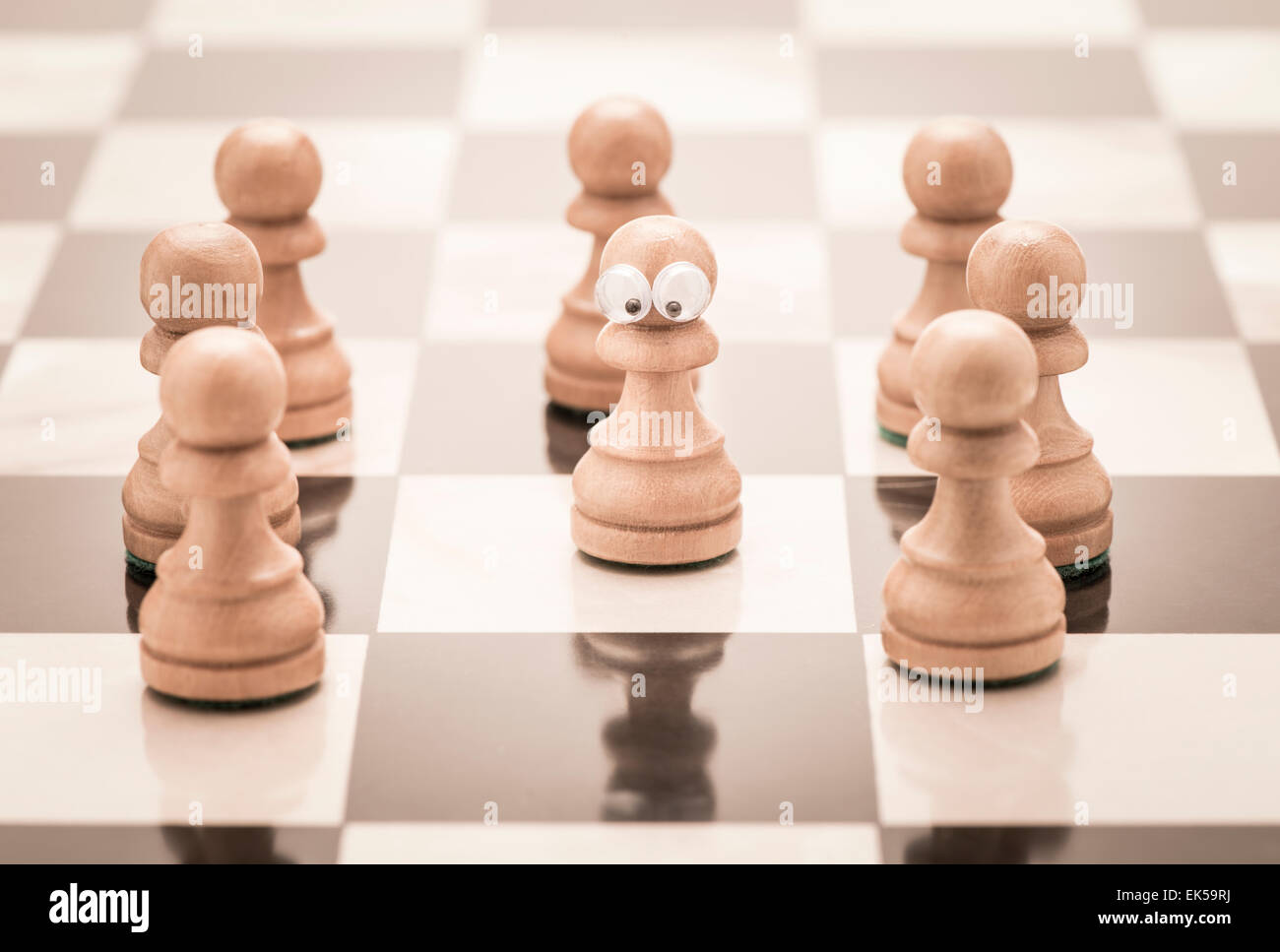 Chess piece with eyes. Conceptual image of childhood and stress. Bullying and being left out. Stock Photo