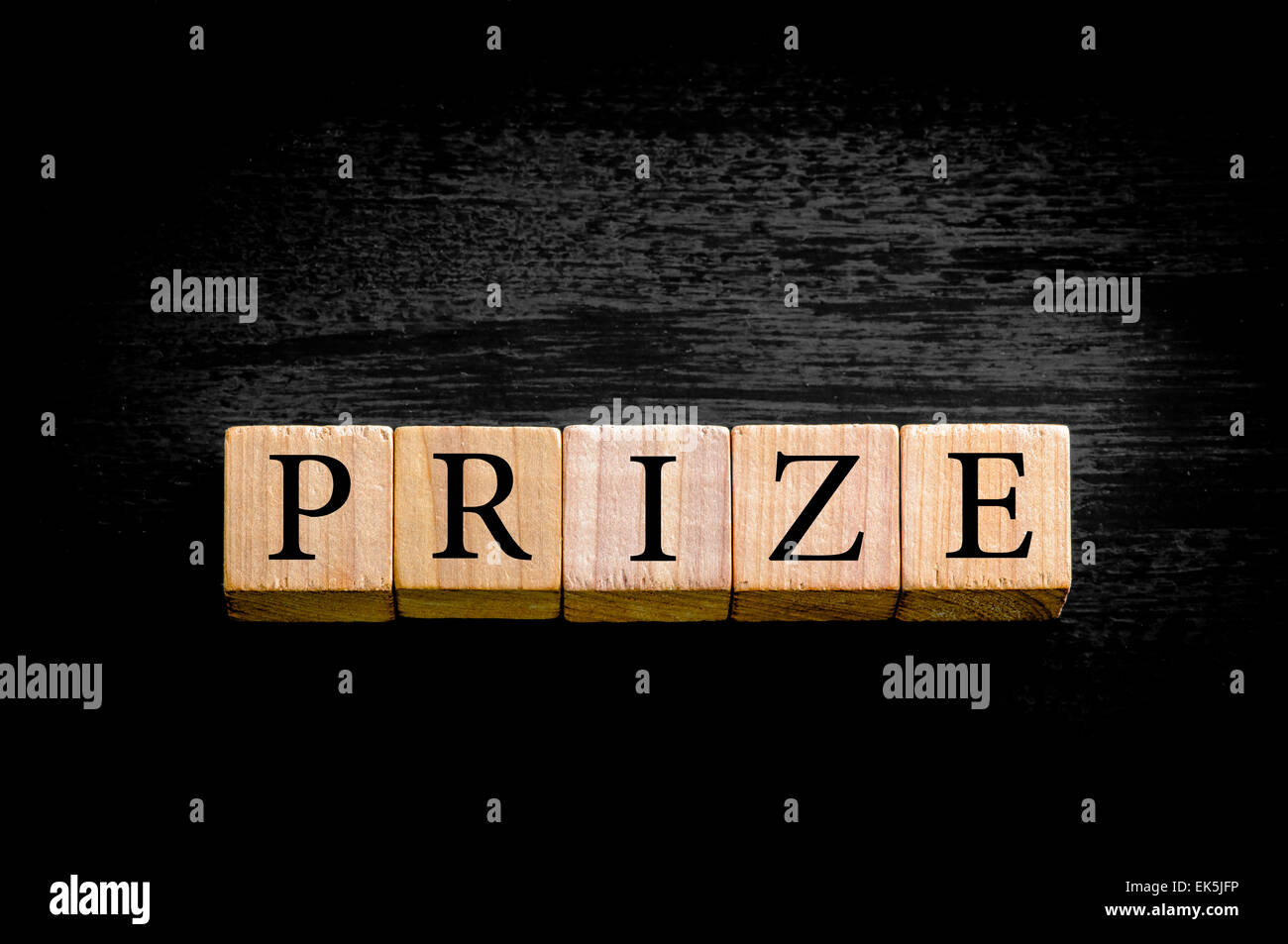 Word PRIZE. Wooden small cubes with letters isolated on black ...