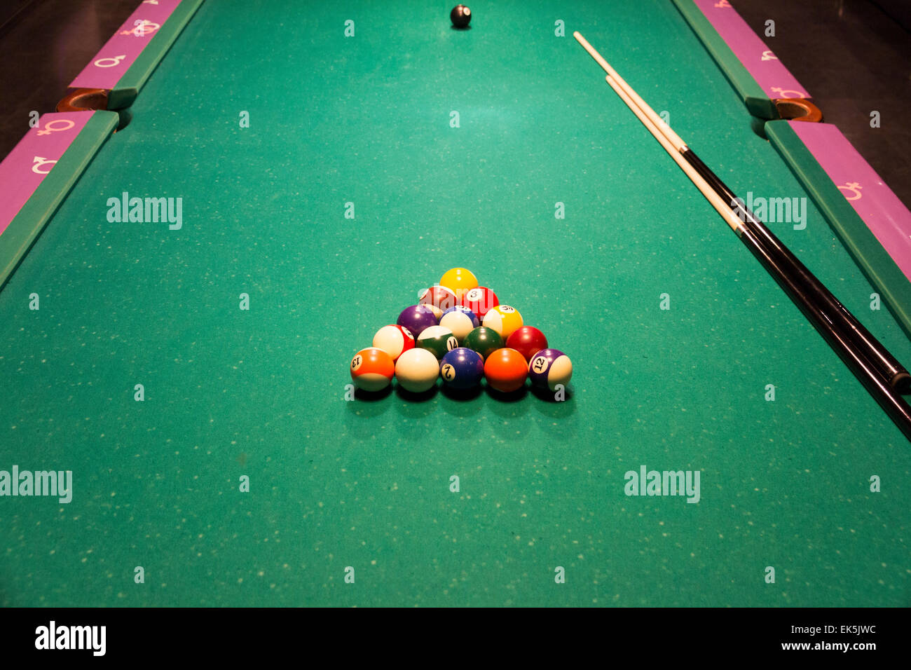 Pool table special design for teenagers with cues and balls Stock Photo