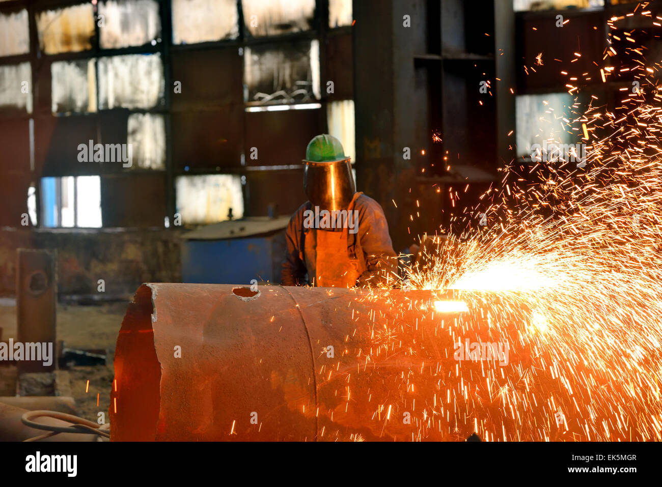 Welder uses torch inside of plant Stock Photo