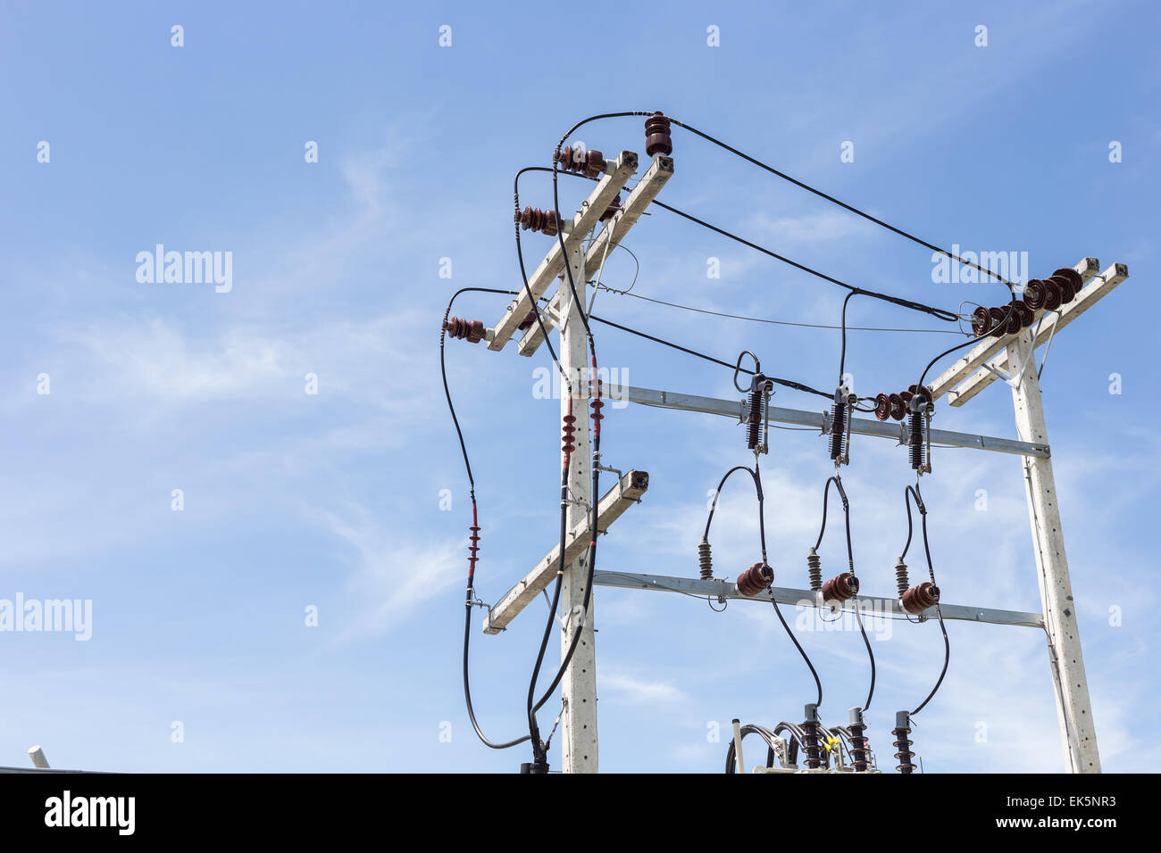 Electric pole and cable with blue sky background Stock Photo - Alamy