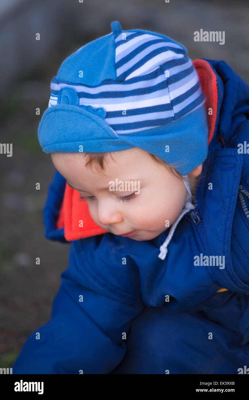 portrait-of-1-year-old-baby-boy-playing-outside-in-spring-stock-photo