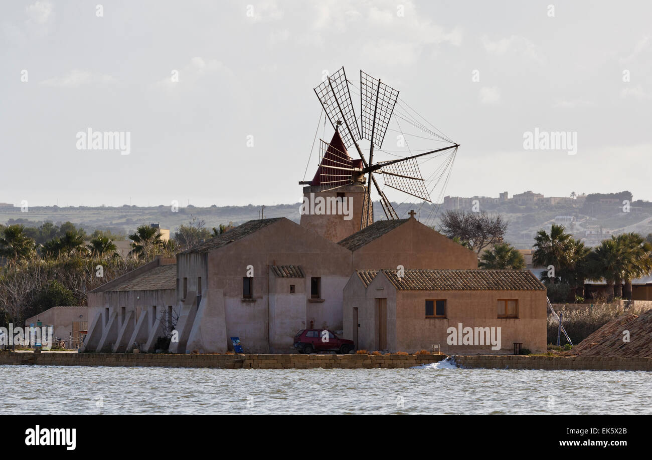 Italy, Sicily, Marsala (Trapani), Mozia salt flats and windmill Stock Photo