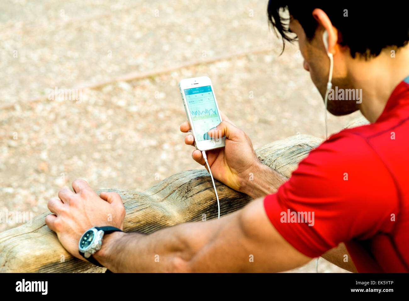 A guy that is reviewing his sport performance on his mobile phone after running Stock Photo