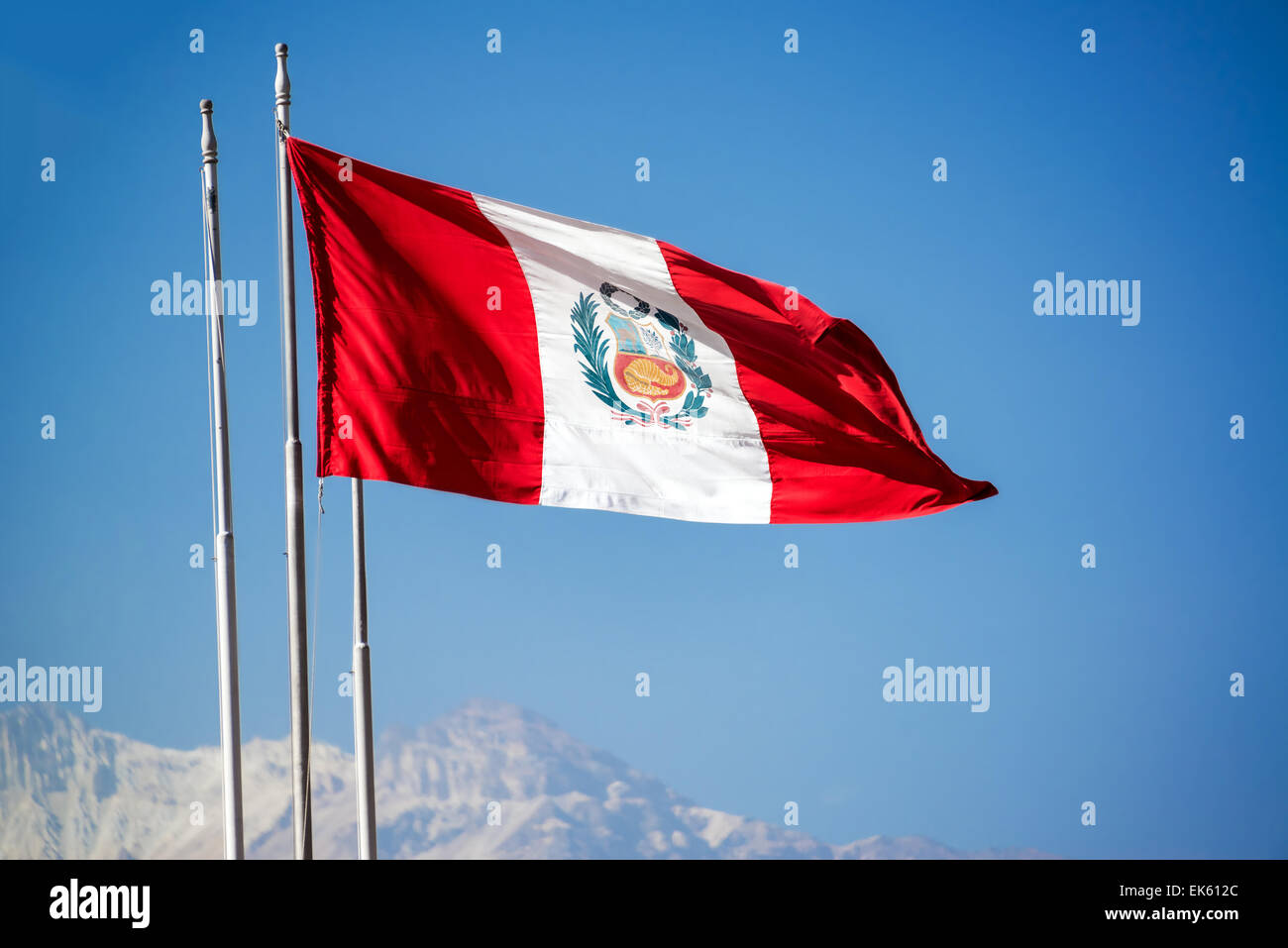 Peruvian flag waving in the air in Arequipa, Peru with El Misti volcano visible in the background Stock Photo