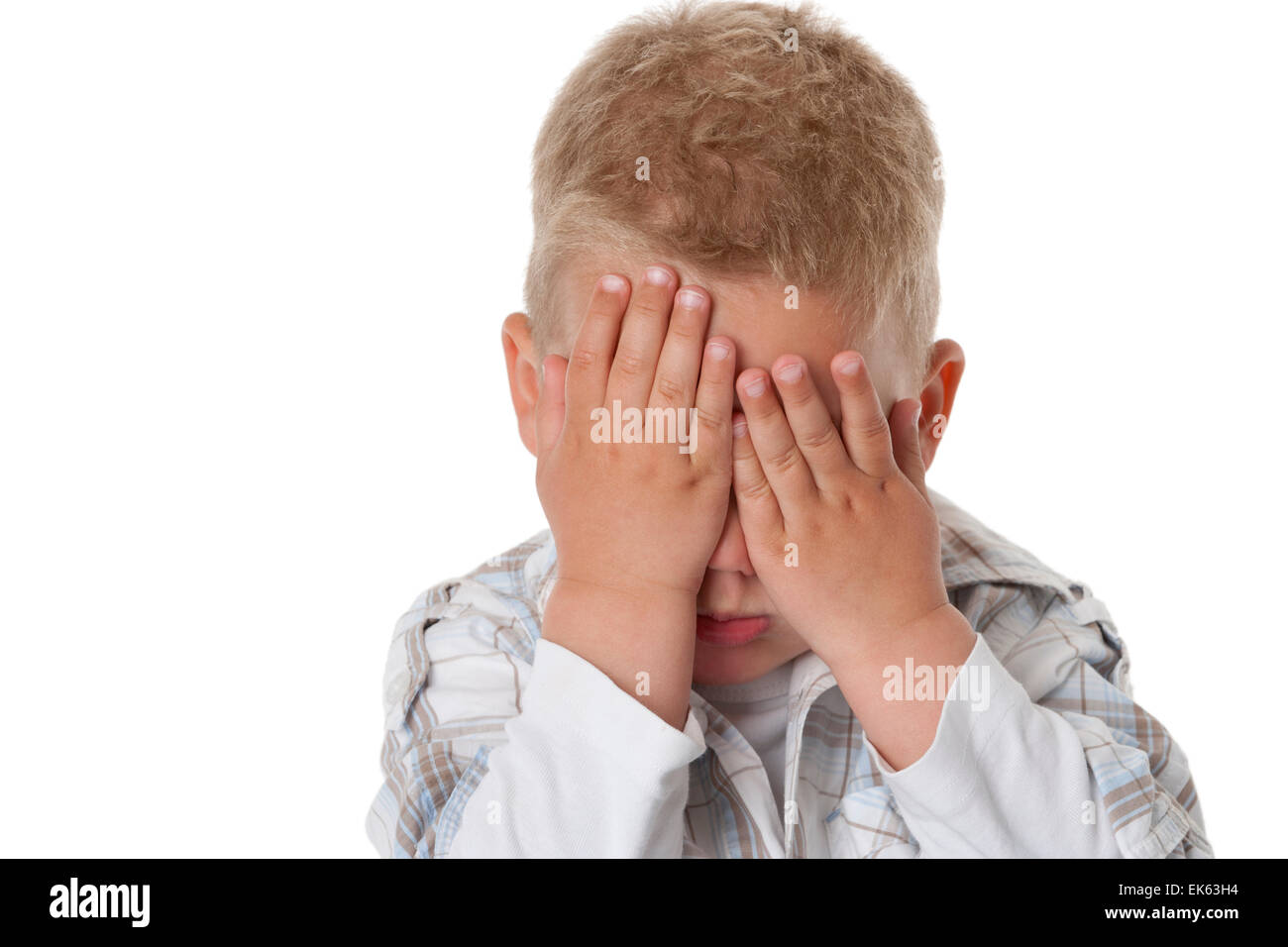 Portrait of a little boy with his hands for his eyes on white ...